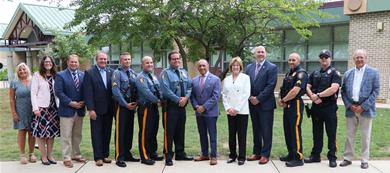 local officials, county officials, police officers and others in a group photo in front of the elementary school local officials, county officials, police officers and others in a group photo in front of the elementary school